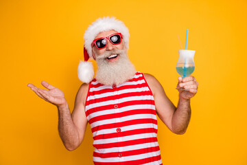 Wall Mural - Photo of cool good mood senior guy dressed christmas swimwear sunglass drinking cocktail isolated yellow color background