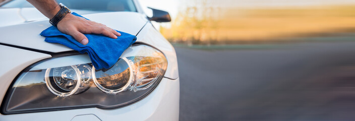 man cleaning car with cloth