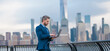 © Volodymyr - Business man with laptop in New York City. Business man in Financial Manhattan, banner. Office worker hold laptop against cityscape in NYC. Business man using laptop outdoor. Business work on laptop.