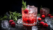 Chilled berry cocktail with raspberries and rosemary. Artisan cocktail with fresh berries, aromatic rosemary on dark background with berries and ice cubes.