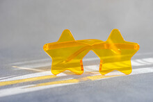 Close-up Of A Pair Of Yellow Star Shaped Novelty Glasses On A  Table