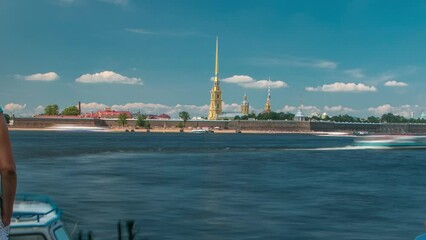 Wall Mural - Neva River Flanked by Peter and Paul Fortress in St. Petersburg, Russia, Showcased in this Timelapse. View from Winter channel with boats and tourists. The Iconic Landmark Stands Tall