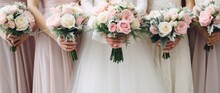 A group of bridesmaids holding bouquets of flowers