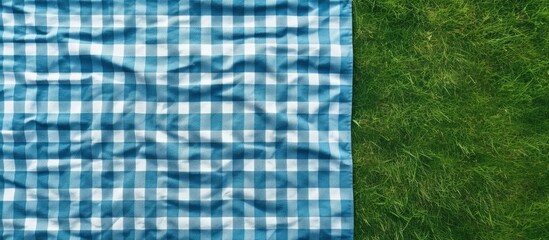 Poster - Top view of a country style checkered towel on green grass serving as a backdrop for a food advertisement display Copy space image Place for adding text or design