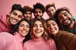 © Valeriia - Banner of group of multiracial friends taking selfie picture smiling at camera. Laughing young people celebrating on pink studio background. Portrait of student guys and girls enjoying time together