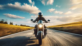 Fototapeta Panele - front view of a motorcycle or motorbike driving fast on road in rural landscape .ai generated
