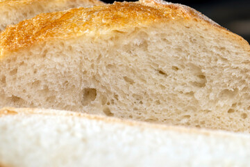 Wall Mural - wheat loaf of bread close-up on the table