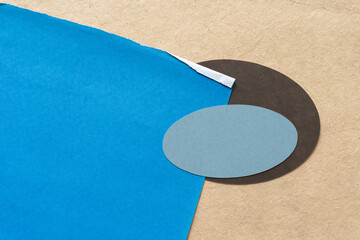 Wall Mural - blue tissue paper with gray and brown oval on plain cardboard