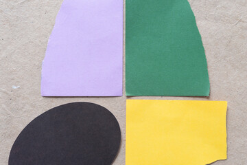 Sticker - torn purple, green, oval, and yellow paper shapes on brown