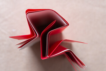 Canvas Print - folded red and white paper standing on end close-up