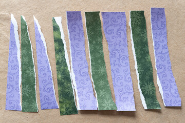 Sticker - decorative green and purple scrapbooking paper torn into strips and arranged on plain brown paper