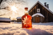 Bottle of maple syrup on the last snow with the sugar shack in the distance.