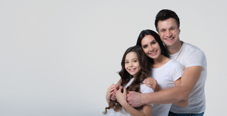 Close up photo of beautiful and smiling family team is posing in a white t-shirt while they isolated on white background in studio.