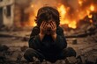 a little boy is crying covering his face with his hands against the backdrop of a war explosion