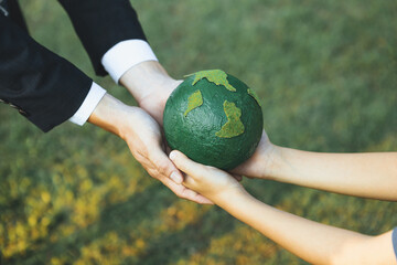 Wall Mural - Businessman hand giving Earth globe to little boy as Earth day concept as corporate social responsible to contribute greener environmental protection for sustainable future generation. Gyre