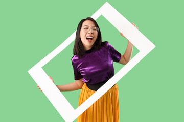 Poster - Beautiful stylish Asian woman with frame on green background