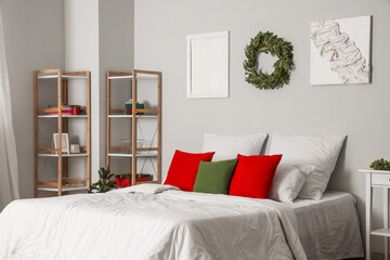 Poster - Interior of light bedroom with Christmas wreath and shelf units