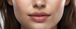 Close-up of perfect natural lip makeup. Photo of beautiful female face. pink glossy plump lips, natural face, beauty and skin care.