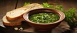 Caldo Verde soup with bread on a wooden table.