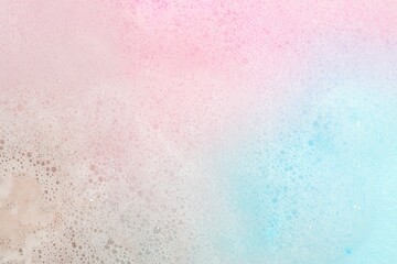 Colorful foam after dissolving bath bomb in water, closeup