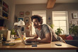 © gankevstock - young Hispanic man concentrates on his laptop in a well decorated home office space