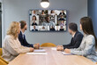 © fizkes - On-line conference, virtual meeting event use worldwide application for distancing communication, business. Group of multiethnic businesspeople take part in videocall at conference in office boardroom