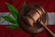 Flag of Austria and justice gavel with cannabis leaf. Illegal growth of cannabis plant and drugs spreading.