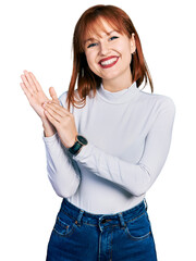 Poster - Redhead young woman wearing casual turtleneck sweater clapping and applauding happy and joyful, smiling proud hands together