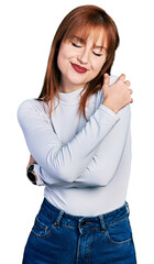 Wall Mural - Redhead young woman wearing casual turtleneck sweater hugging oneself happy and positive, smiling confident. self love and self care