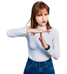 Sticker - Redhead young woman wearing casual turtleneck sweater doing time out gesture with hands, frustrated and serious face