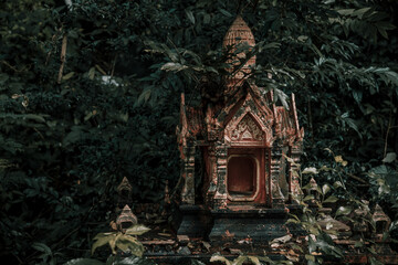 Wall Mural - A beautiful little abandoned temple in the jungle. Green leaves. Ancient architecture of Asia.