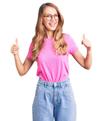 Poster - Young beautiful caucasian woman with blond hair wearing casual clothes and glasses success sign doing positive gesture with hand, thumbs up smiling and happy. cheerful expression and winner gesture.