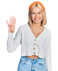 Poster - Beautiful young blonde woman wearing casual white sweater showing and pointing up with fingers number four while smiling confident and happy.