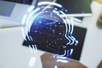 Poster - Creative artificial Intelligence concept with human head hologram and modern digital tablet on background, top view. Multiexposure