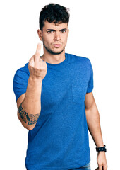 Poster - Young hispanic man wearing casual t shirt showing middle finger, impolite and rude fuck off expression