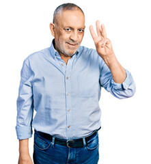 Poster - Senior man with grey hair and beard wearing casual blue shirt showing and pointing up with fingers number three while smiling confident and happy.