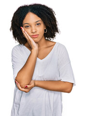 Sticker - Young african american girl wearing casual clothes thinking looking tired and bored with depression problems with crossed arms.