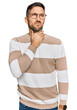 Handsome man with beard wearing casual clothes and glasses touching painful neck, sore throat for flu, clod and infection