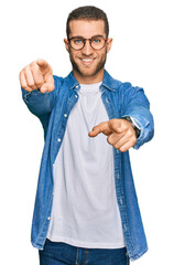 Canvas Print - Young caucasian man wearing casual clothes pointing to you and the camera with fingers, smiling positive and cheerful