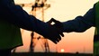 Teamwork engineers, partners shaking hands, good work. Team of power engineers construction workers, woman, man work together. Energy business, partners make a deal. Businessmen handshake close-up