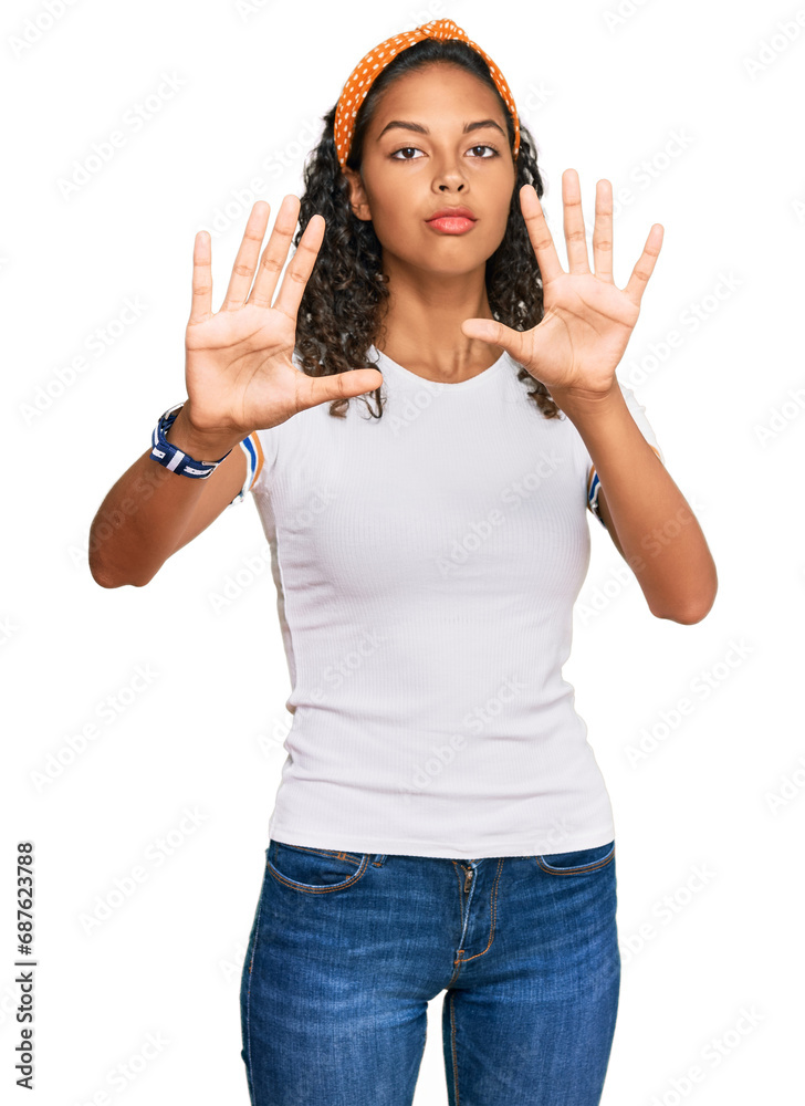 Young african american girl wearing casual clothes doing frame using hands palms and fingers, camera perspective