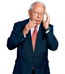 Canvas Print - Senior man with grey hair wearing business suit and glasses tired hands covering face, depression and sadness, upset and irritated for problem