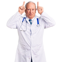 Poster - Senior handsome grey-haired man wearing doctor coat and stethoscope doing funny gesture with finger over head as bull horns