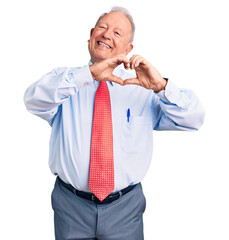 Sticker - Senior handsome grey-haired man wearing elegant tie and shirt smiling in love doing heart symbol shape with hands. romantic concept.