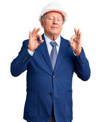 Canvas Print - Senior handsome grey-haired man wearing suit and architect hardhat relax and smiling with eyes closed doing meditation gesture with fingers. yoga concept.