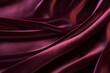 Elegant folds of a smooth deep red burgundy vinous satin velvet fabric with waves background. Textile drapery concept