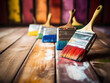 © Kedek Creative - Paintbrush with colorful paint on a wooden floor, ready to paint a work of art