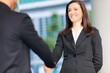 © Minerva Studio - Professional handshake at office building entrance