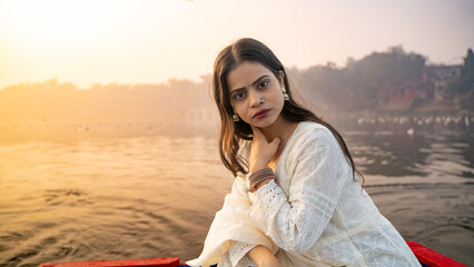 Wall Mural - Portrait of a beautiful Indian girl, wearing traditional dress, outdoor nature background