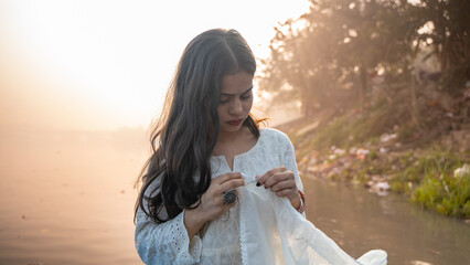 Wall Mural - Portrait of a beautiful Indian girl, wearing traditional dress, outdoor nature background